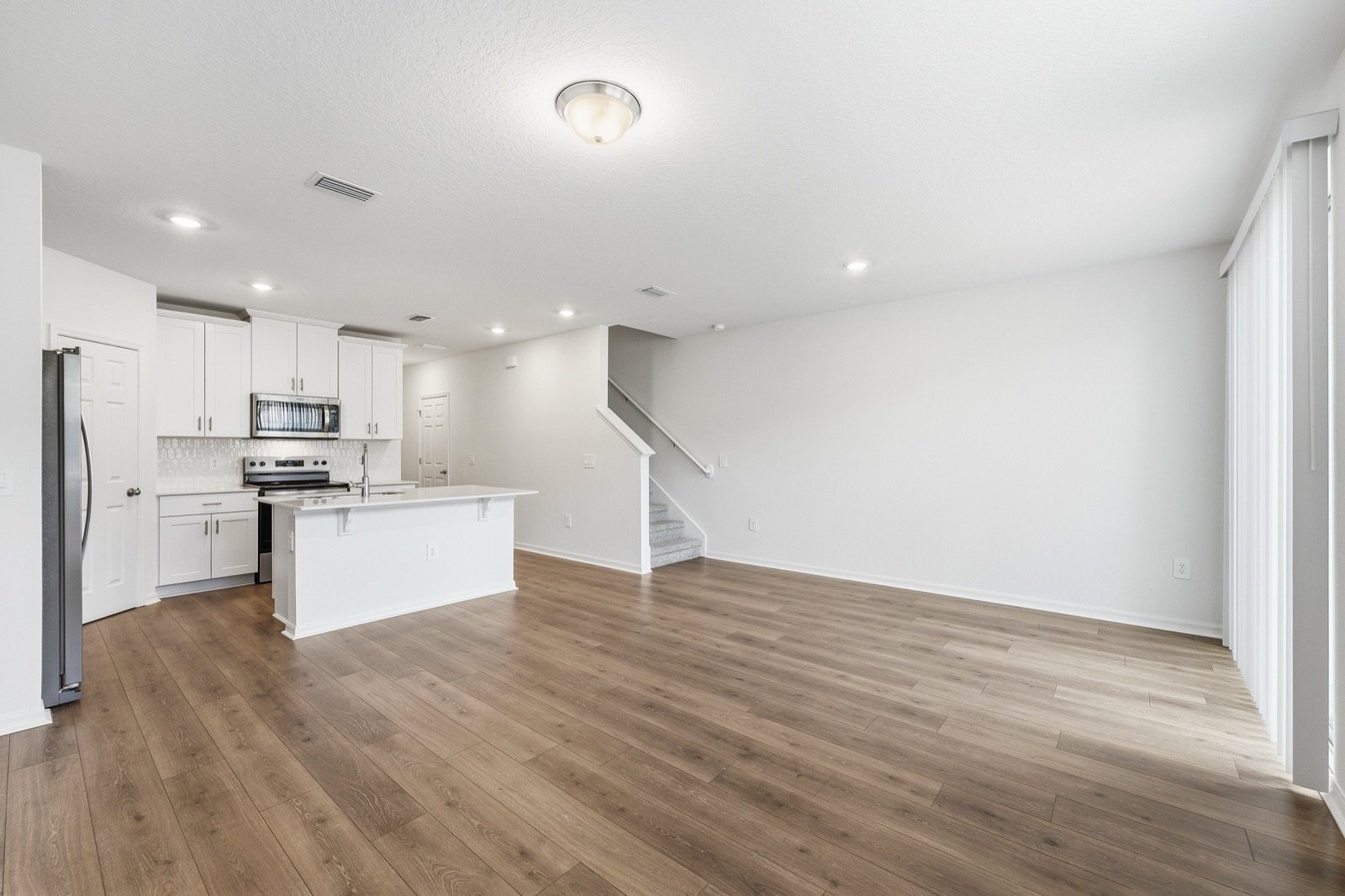 Living and kitchen area before virtual staging